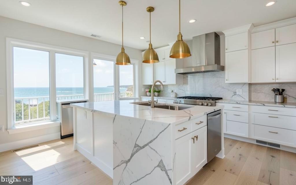 Bright coastal kitchen with white cabinets